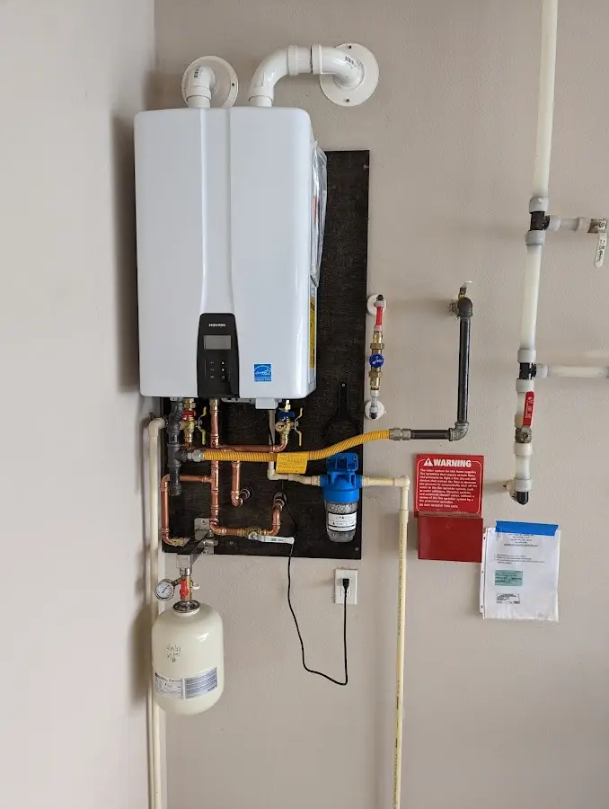 Professional plumber installing copper piping in a Evansdale home